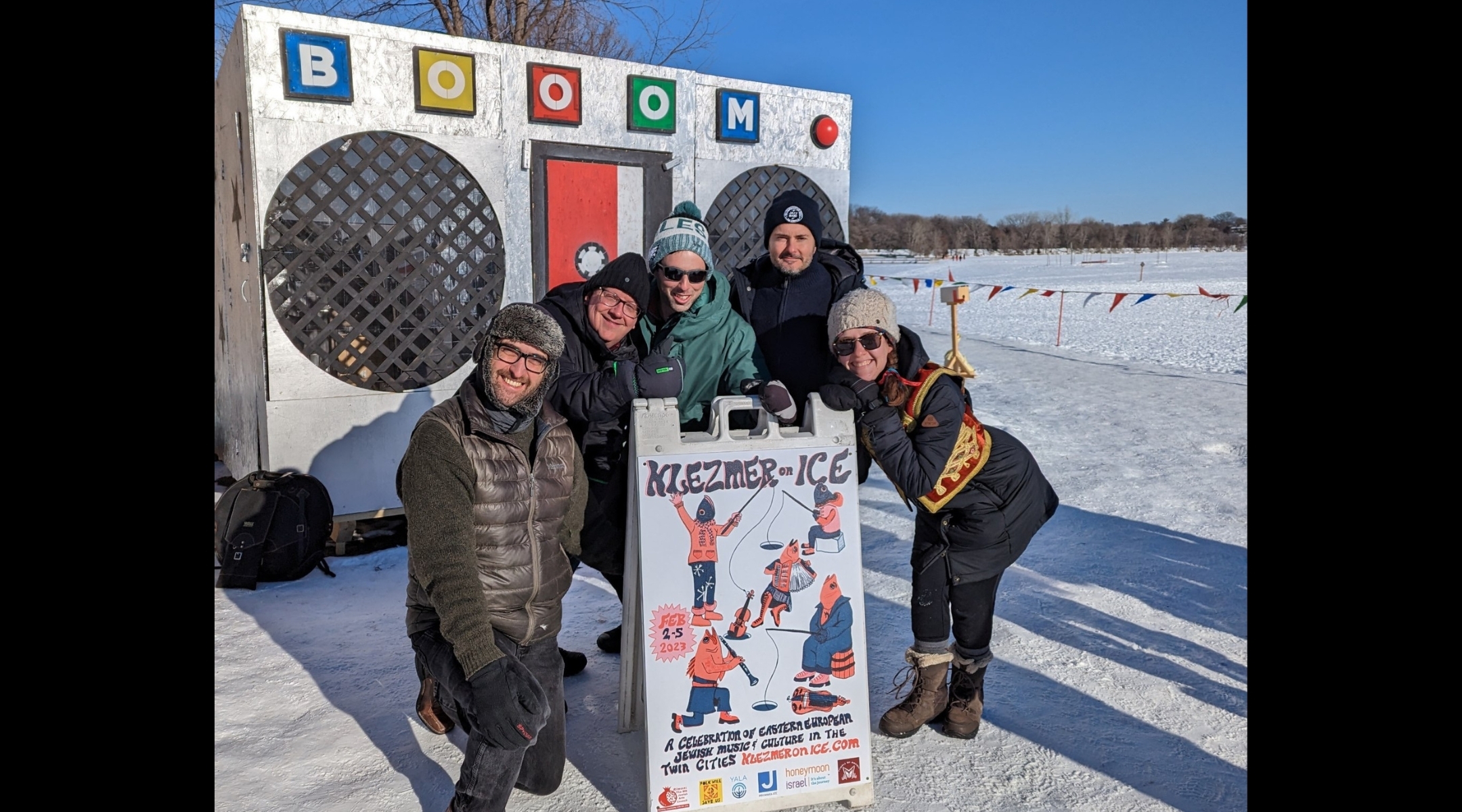 From left to right: klezmer musicians Greg Schweser, Pat O’Keefe, Josh Rosard, Michael Leville, and Sarah Larsson pose for a picture in front of the Art Shanty popup in Minneapolis. (Courtesy of Josh Rosard)