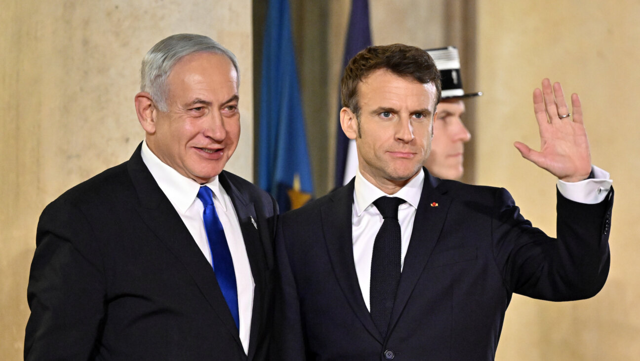 Israeli Prime Minister Benjamin Netanyahu and French President Emmanuel Macron pose prior to a working dinner at the Elysee Palace in Paris, Feb. 2, 2023. (Mustafa Yalcin/Anadolu Agency via Getty Images)