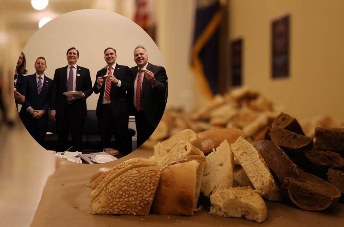 Rep. Daniel Goldman (center, with a plate) offered a spread of bagels to colleagues in Congress. 