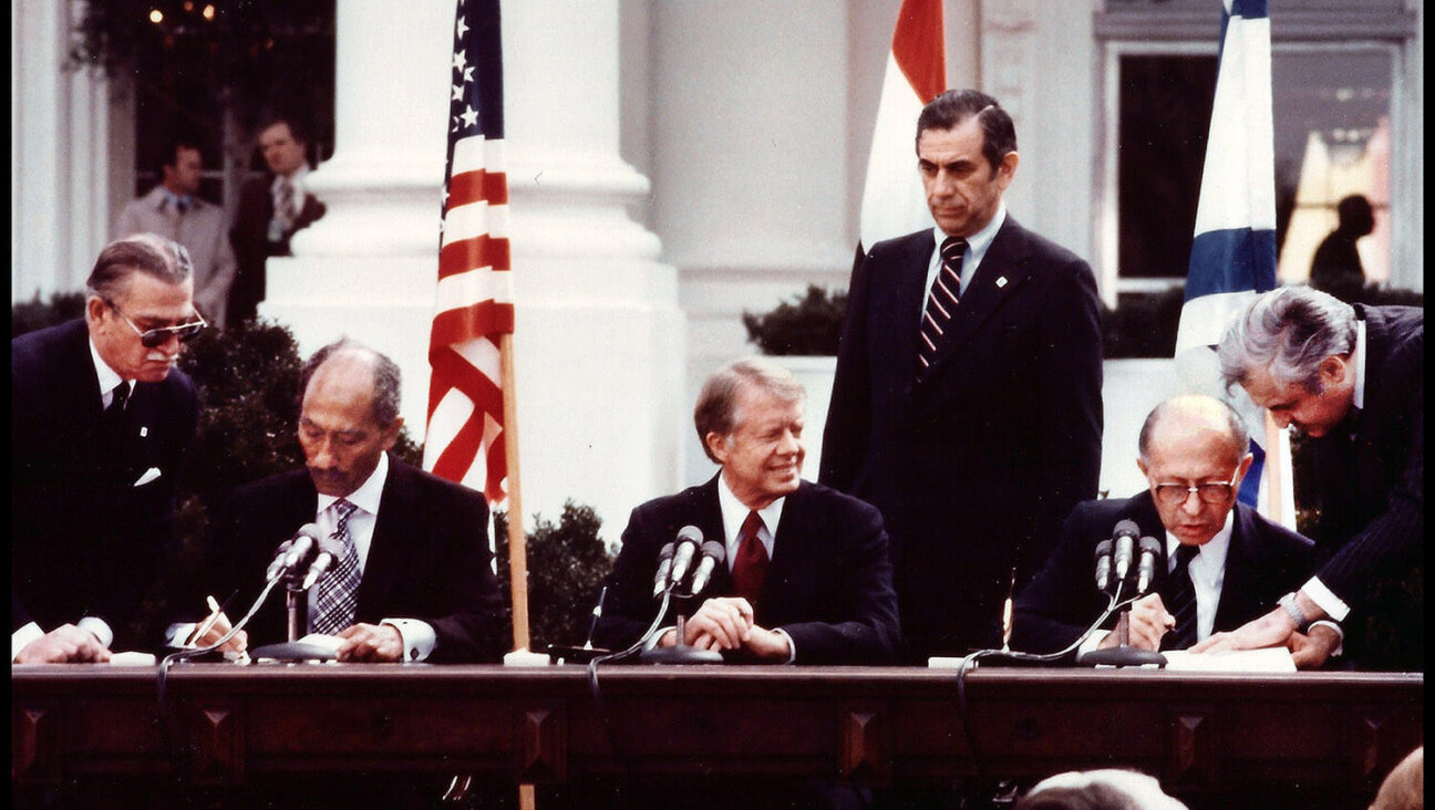 Jimmy Carter, Egypt's President Anwar Sadat and Israel's Prime Minister Menachem Begin sign the Egyptian-Israeli Peace Treaty at the White House on March 26, 1979.