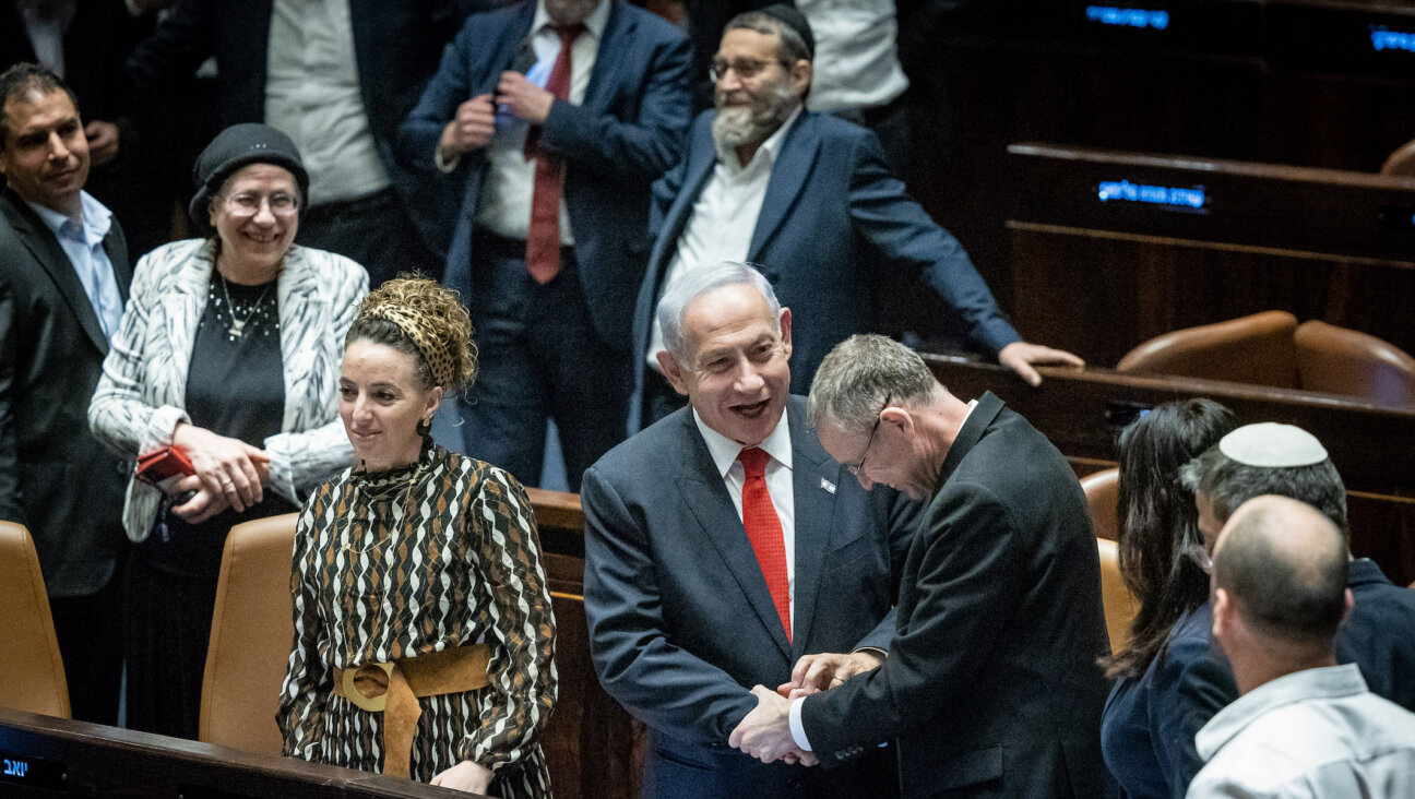 Israeli Prime Minister Benjamin Netanyahu and his allies celebrate a vote advancing key pieces of his coalition’s judicial reform. (Yonatan Sindel/Flash90)