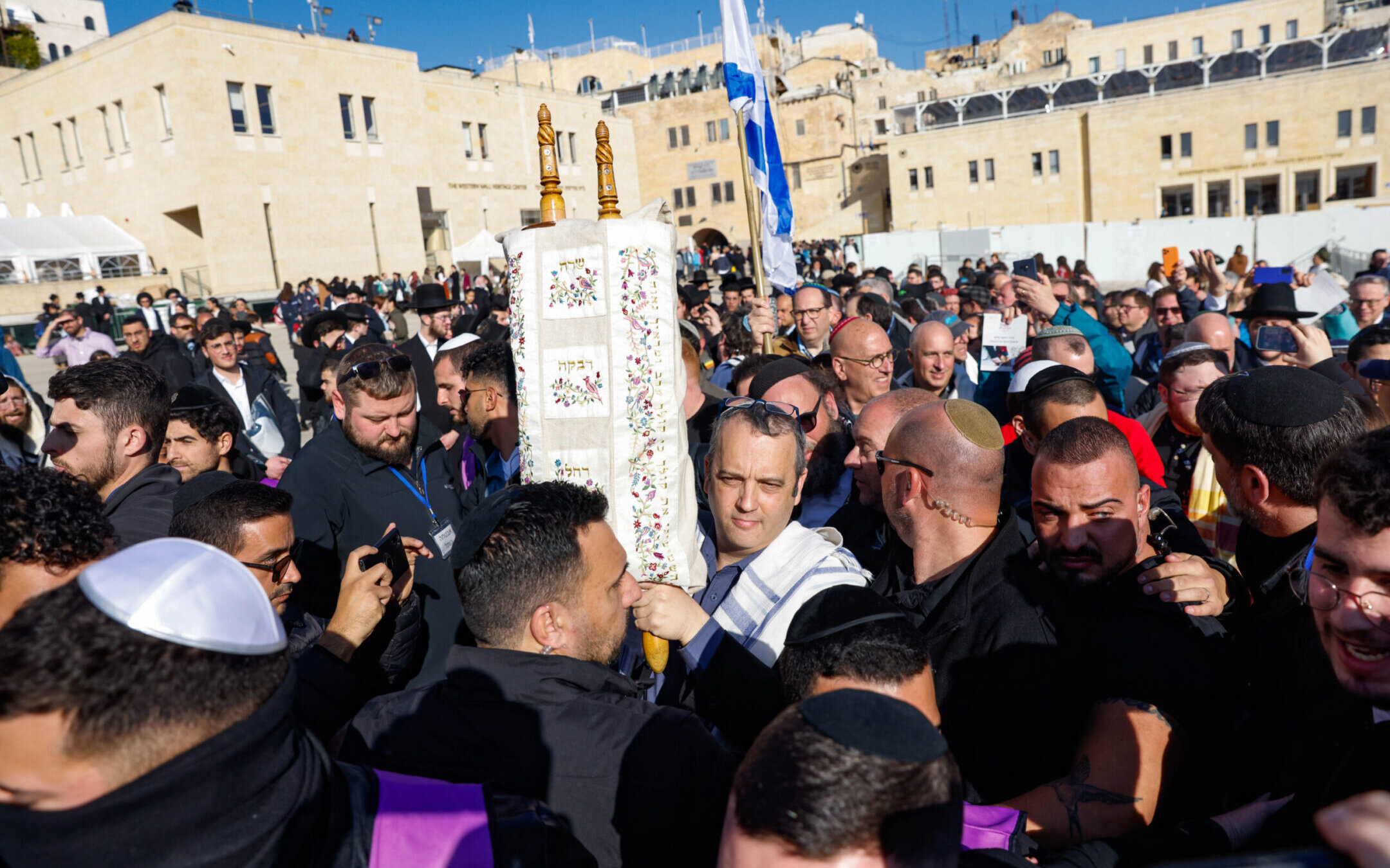 Gilad Kariv, a member of Knesset, holds a Torah scroll during Rosh Hodesh prayer of Women of the Wall, at the Western Wall in Jerusalem, Feb. 22, 2023. (Erik Marmor/Flash90)