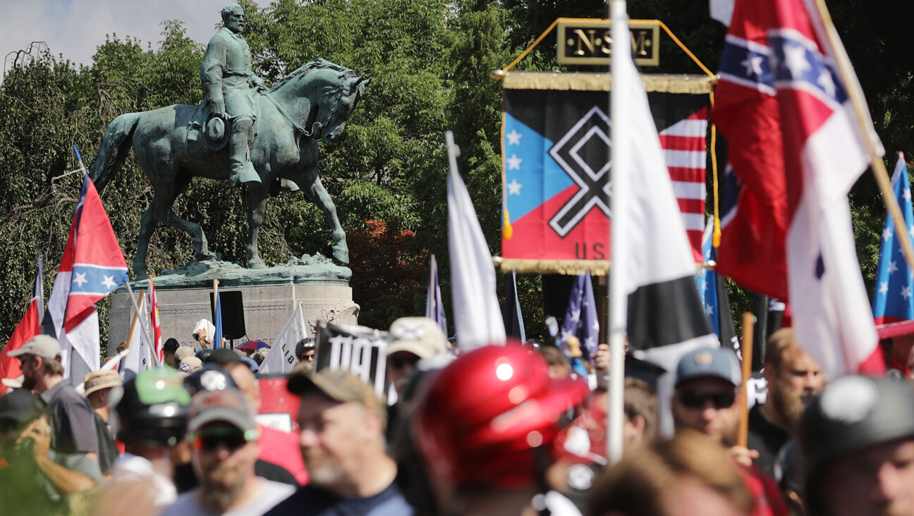 A Confederate statue stands behind a crowd of white nationalists and neo-Nazis during the 2017 "Unite the Right" rally in Charlottesville, Virginia. A new survey found that Southern Jews experienced higher rates of antisemitism than those living elsewhere in the country.