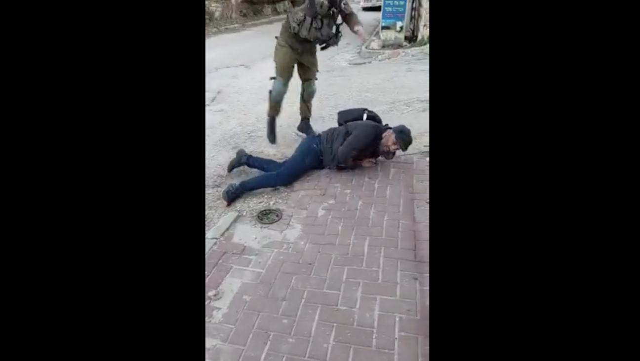 A video showing an Israeli soldier throwing a Palestinian activist to the ground and kicking him went viral, resulting in the soldier being jailed for 10 days. (Screenshot)