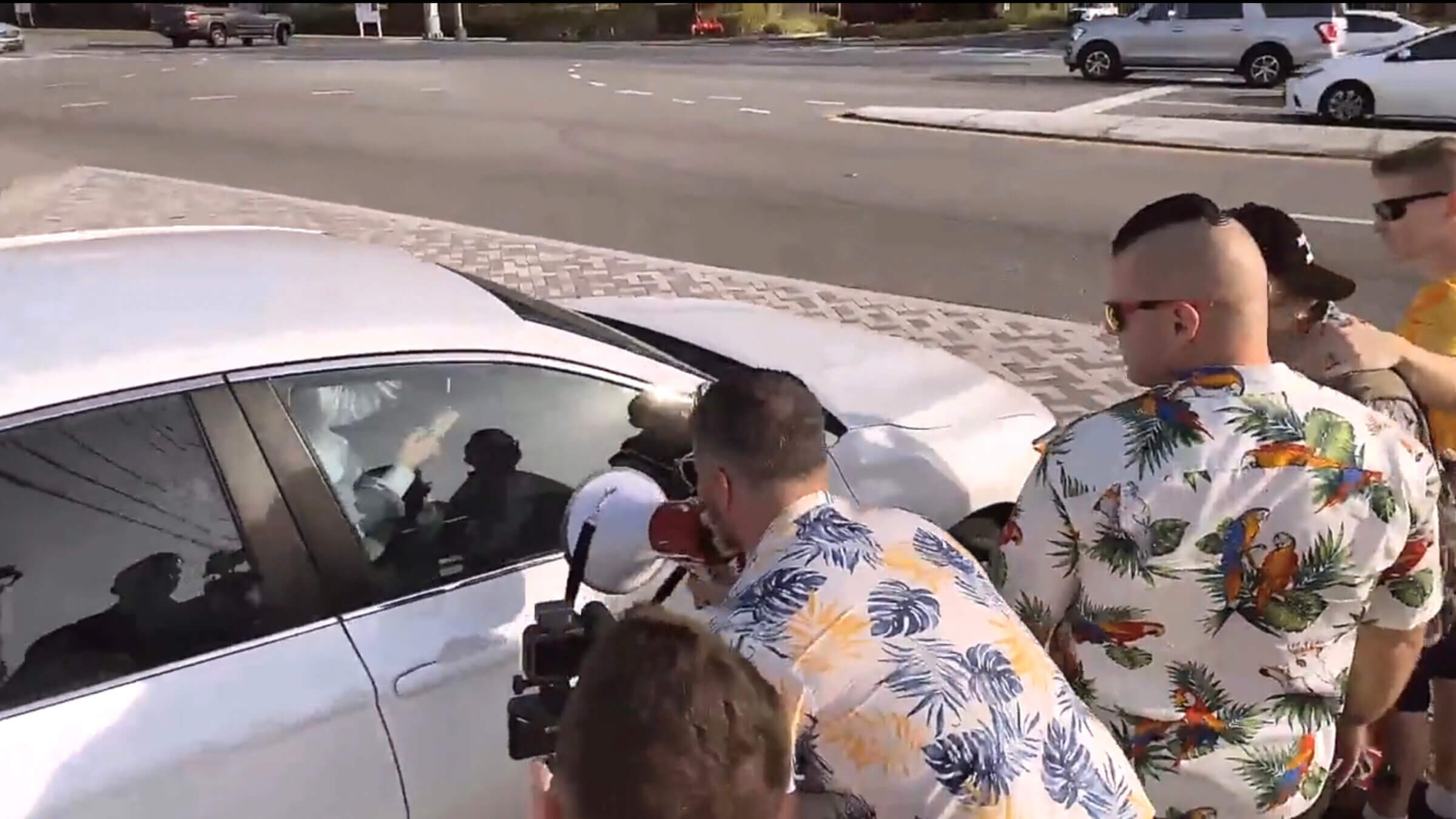 Members of the Goyim Defense League including Jon Minadeo, holding the megaphone, harass a Jewish man leaving Chabad of South Orlando on Friday.