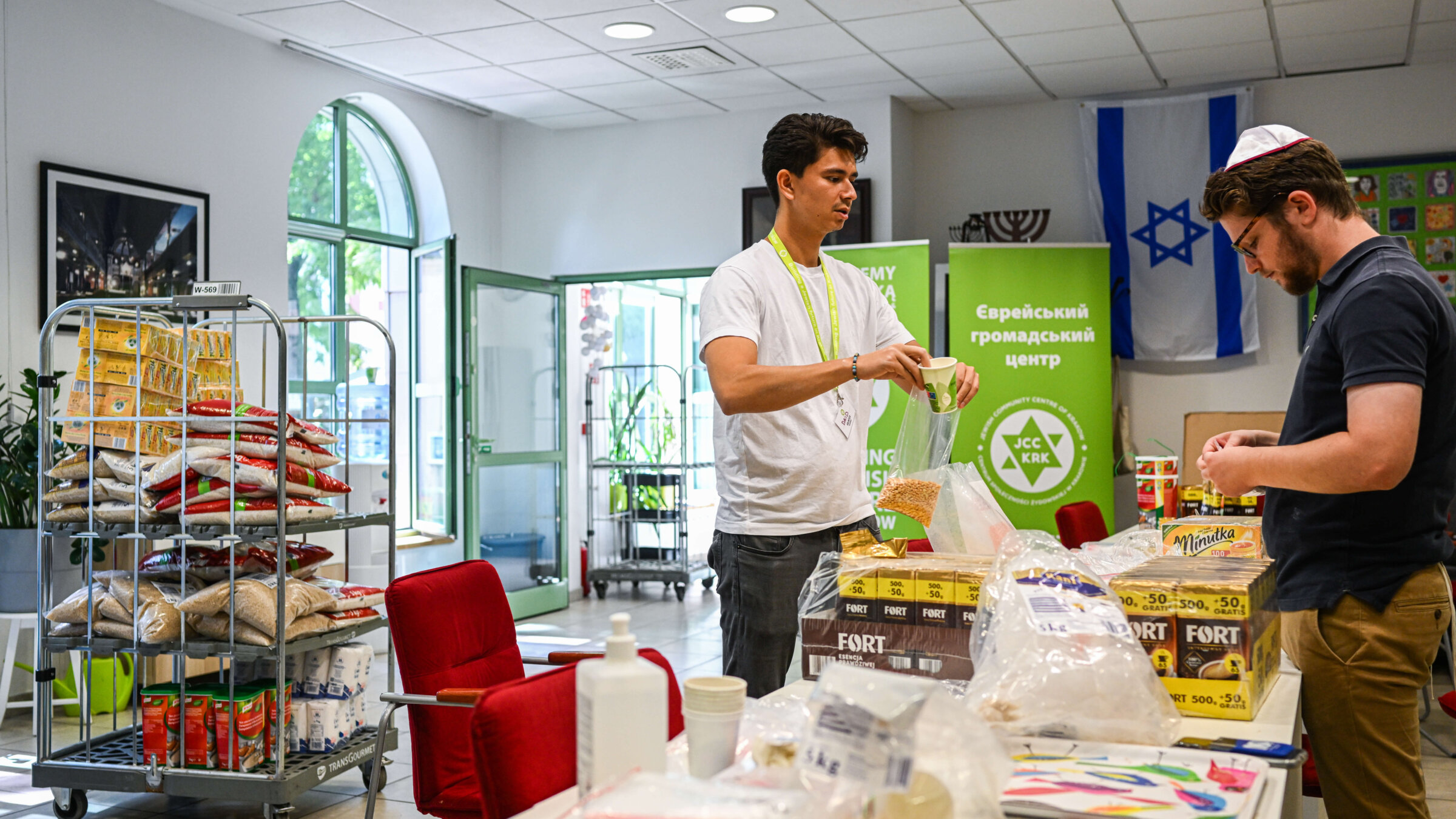 Volunteers from the Jewish community prepare donation packages at the Jewish Community Center on July 15, 2022 in Krakow, Poland. 