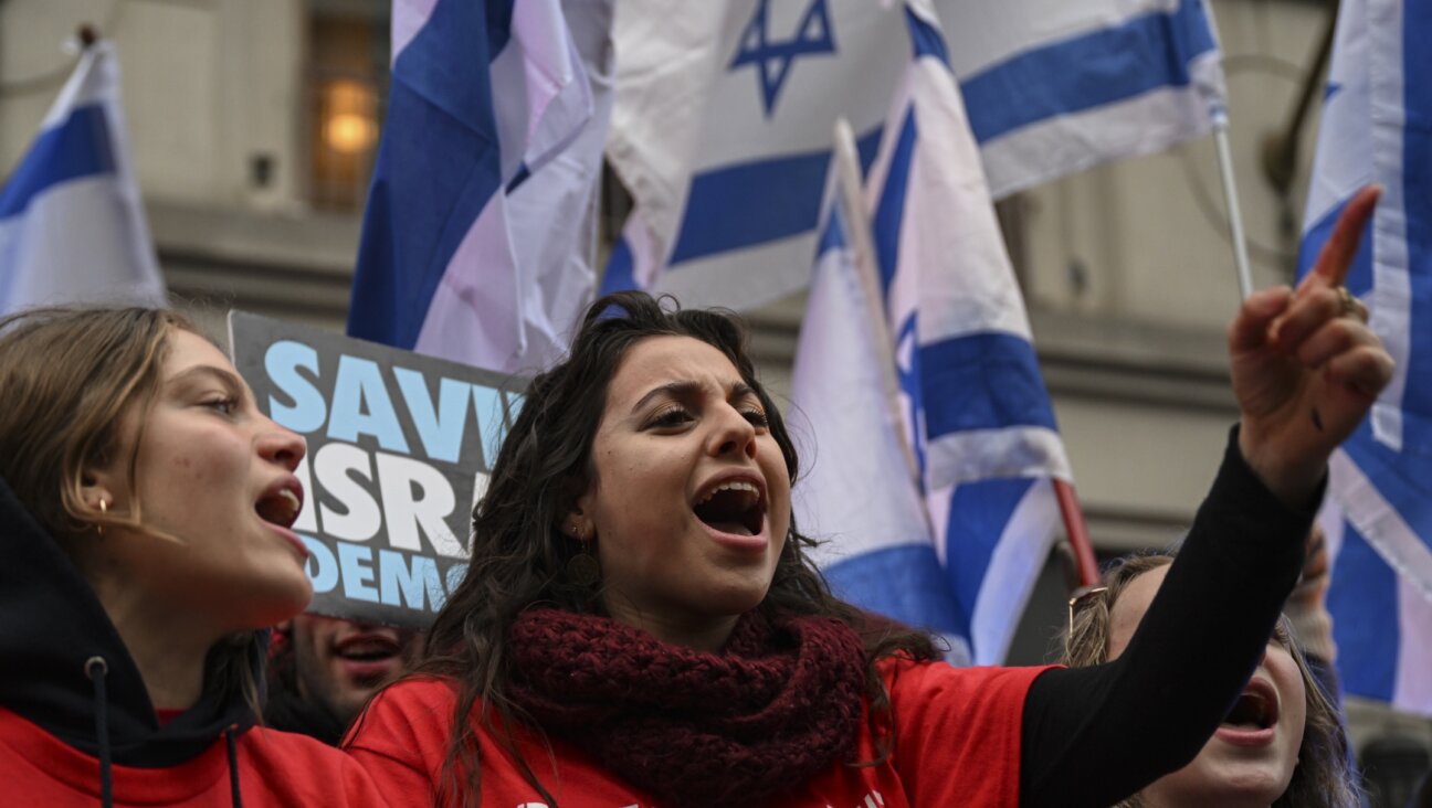People holding banners and Israeli flags gather to protest Israeli Finance Minister Bezalel Smotrich outside the Grand Hyatt Hotel where he attends a conference amid an official boycott following his comments on wiping out a Palestinian village of Huwara, in Washington D.C., March 12, 2023. 