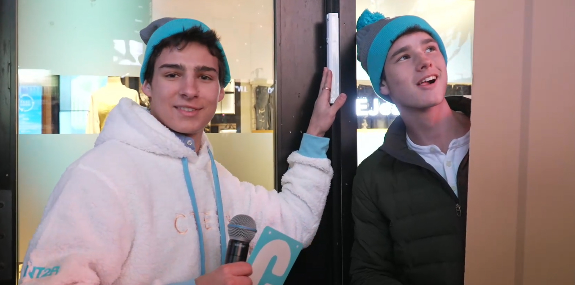 Attendees of a Chabad teen convention in Times Square pose next to the mezuzah affixed to the doorpost of American Eagle Outfitters’ flagship store. (Courtesy of Chabad)