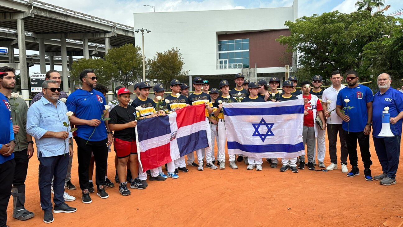 Baseball players from the David Posnack Jewish Day School pose with local Dominican teens at an Israel-Dominican Republic friendship ceremony held at the World Baseball Classic in Miami, March 14, 2023.(Jacob Gurvis)