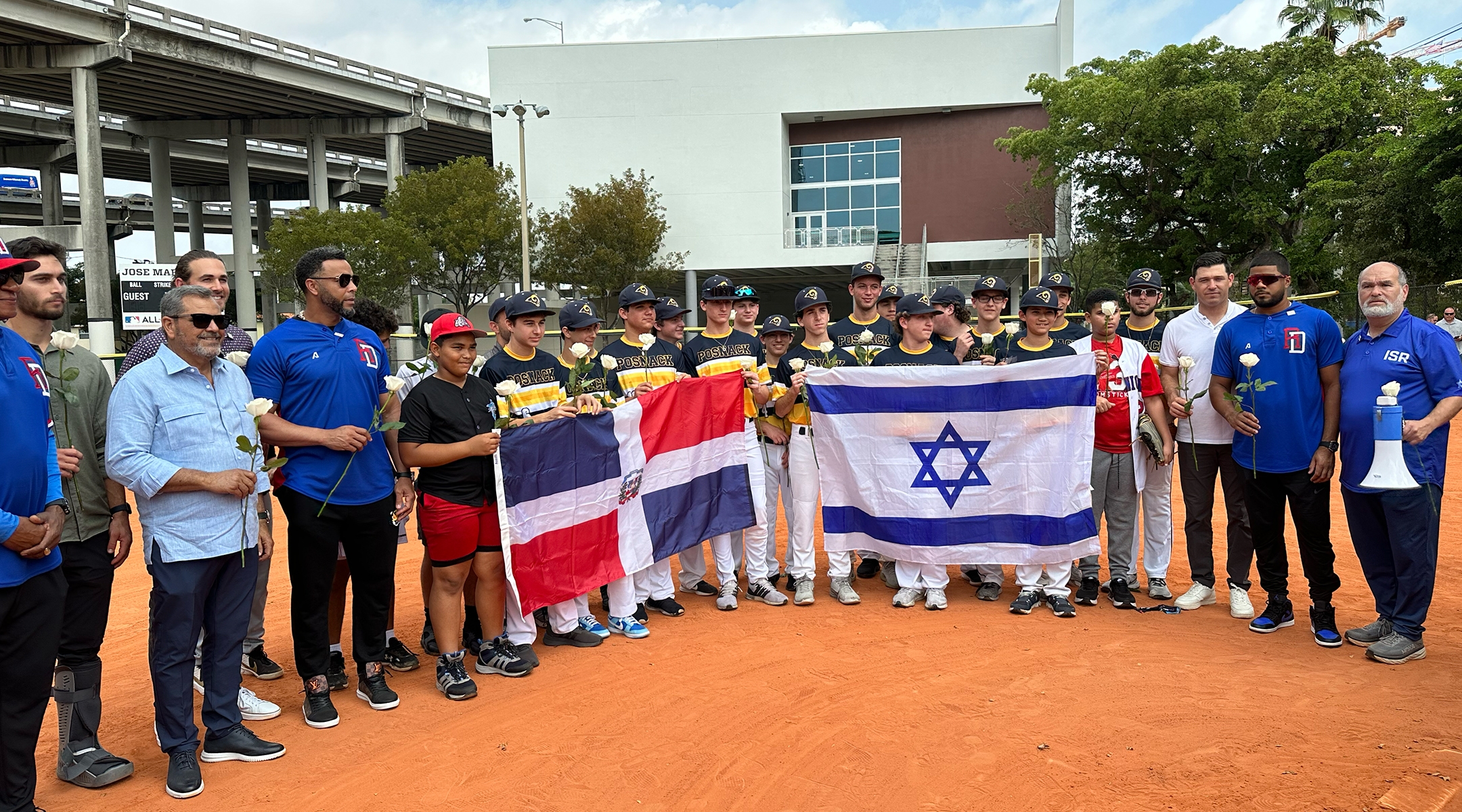 Baseball players from the David Posnack Jewish Day School pose with local Dominican teens at an Israel-Dominican Republic friendship ceremony held at the World Baseball Classic in Miami, March 14, 2023.(Jacob Gurvis)