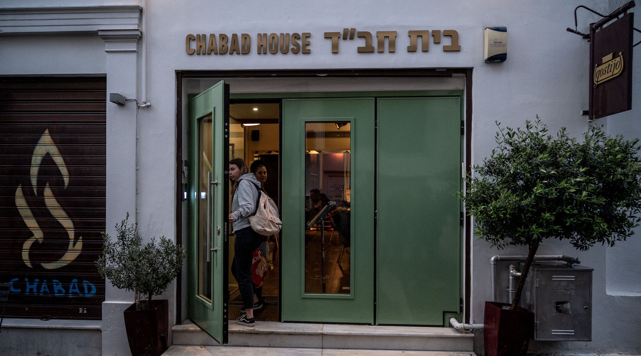 Women enter a Jewish restaurant in central Athens, March 28, 2023. Greek police sources said they arrested two men who targeted the building. (Angelos Tzortzinis/AFP via Getty Images)