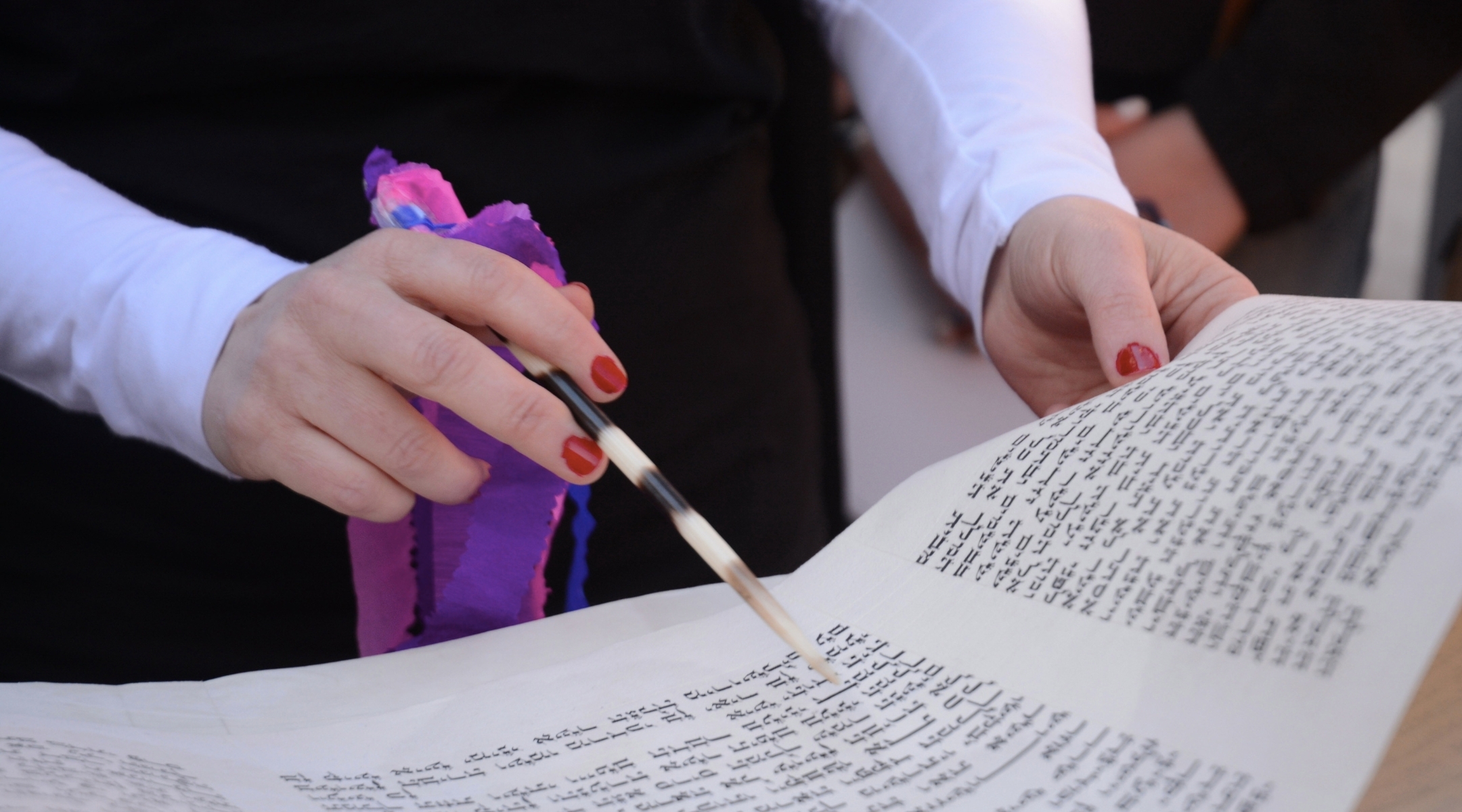 A woman reads from the megillah in Jerusalem. (Pacific Press via Getty)