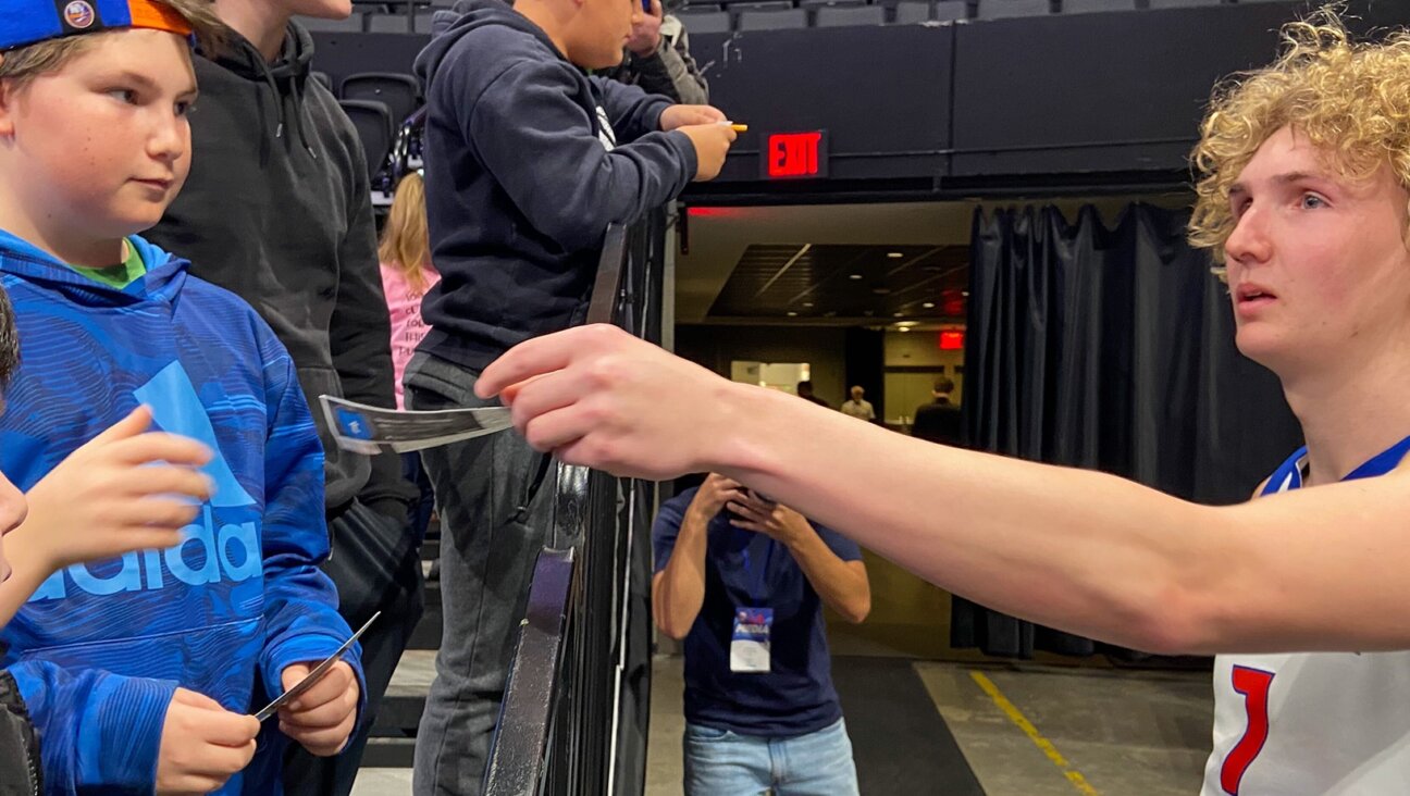 Orthodox NBA G League player Ryan Turell signs autographs for Jewish fans after the at the Nassau Coliseum in Uniondale, New York on Tuesday, March 8, 2023. (Jacob Henry)