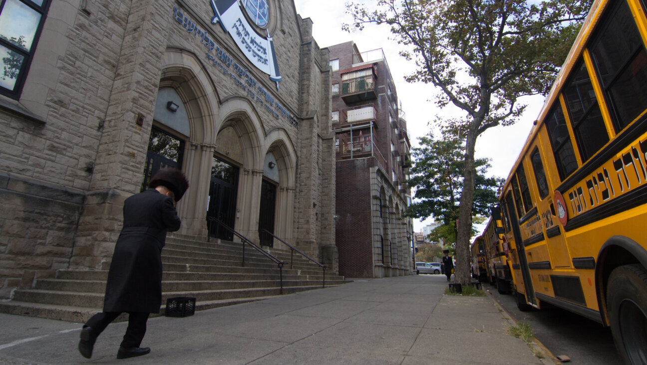 A man walks past an Orthodox yeshiva in Brooklyn, Sept. 29, 2020. (Daniel Moritz-Rabson)