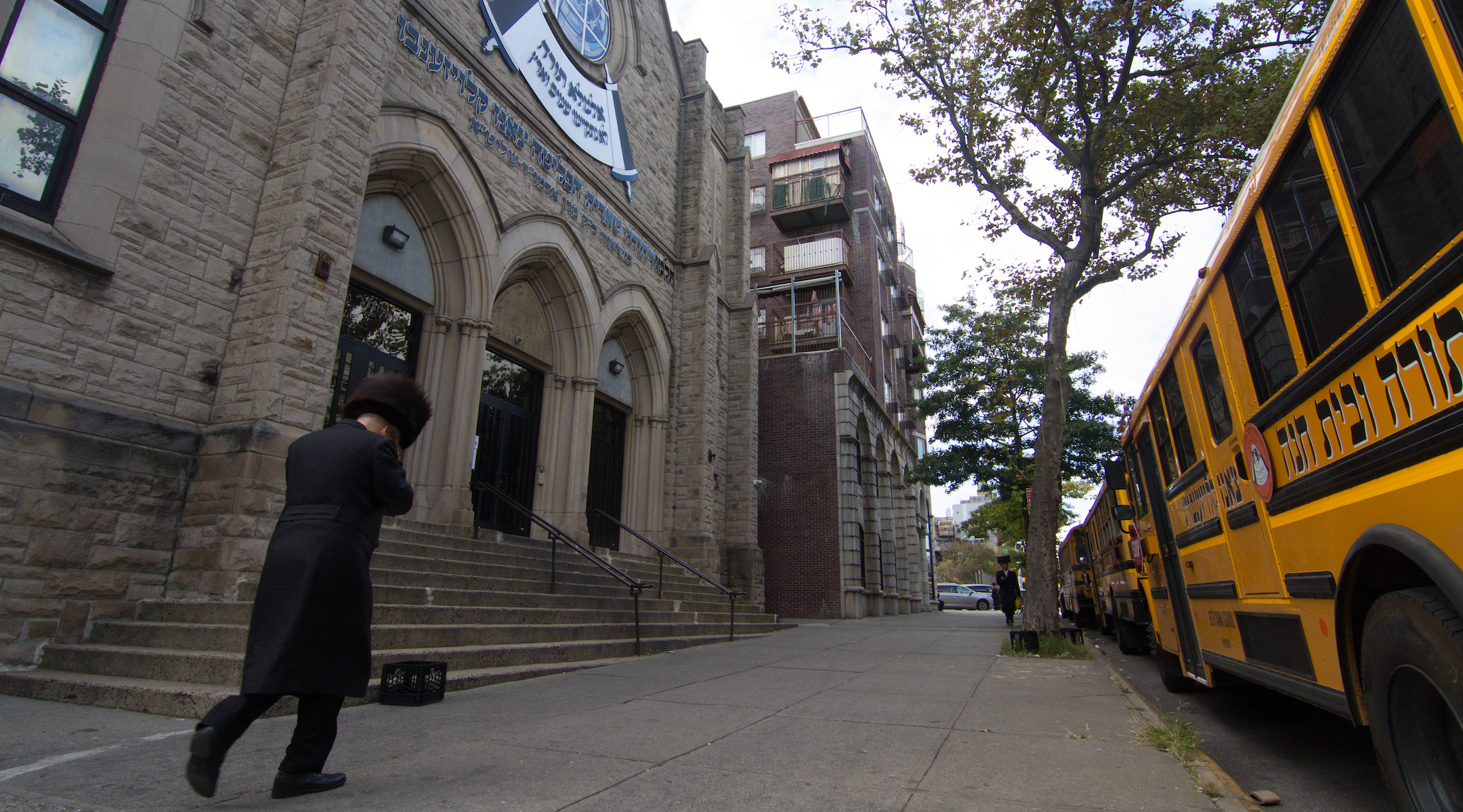 A man walks past an Orthodox yeshiva in Brooklyn, Sept. 29, 2020. (Daniel Moritz-Rabson)