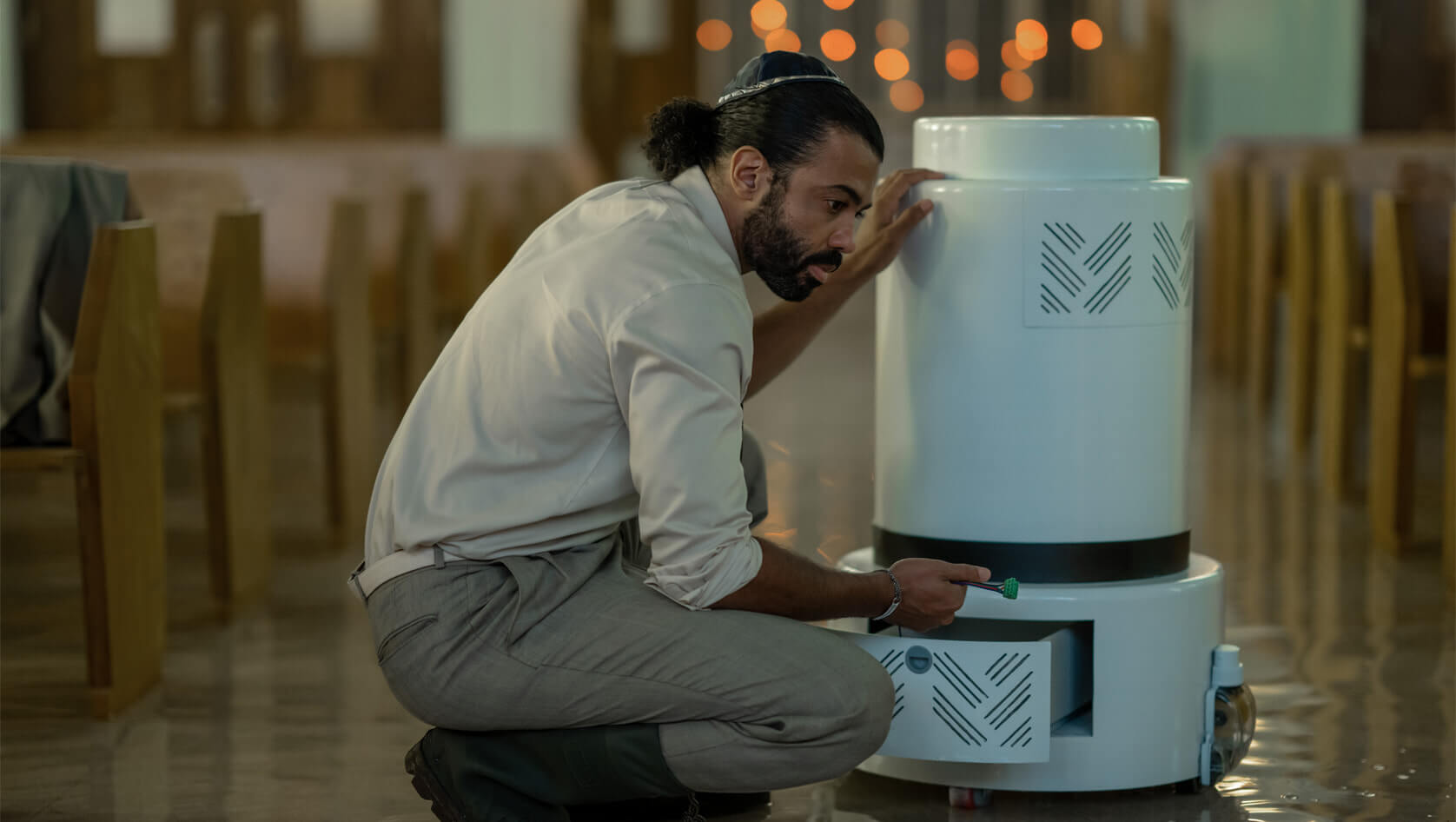 Marshall Zucker (Daveed Diggs) with a water-pumping robot in <i>Extrapolations.</i>
