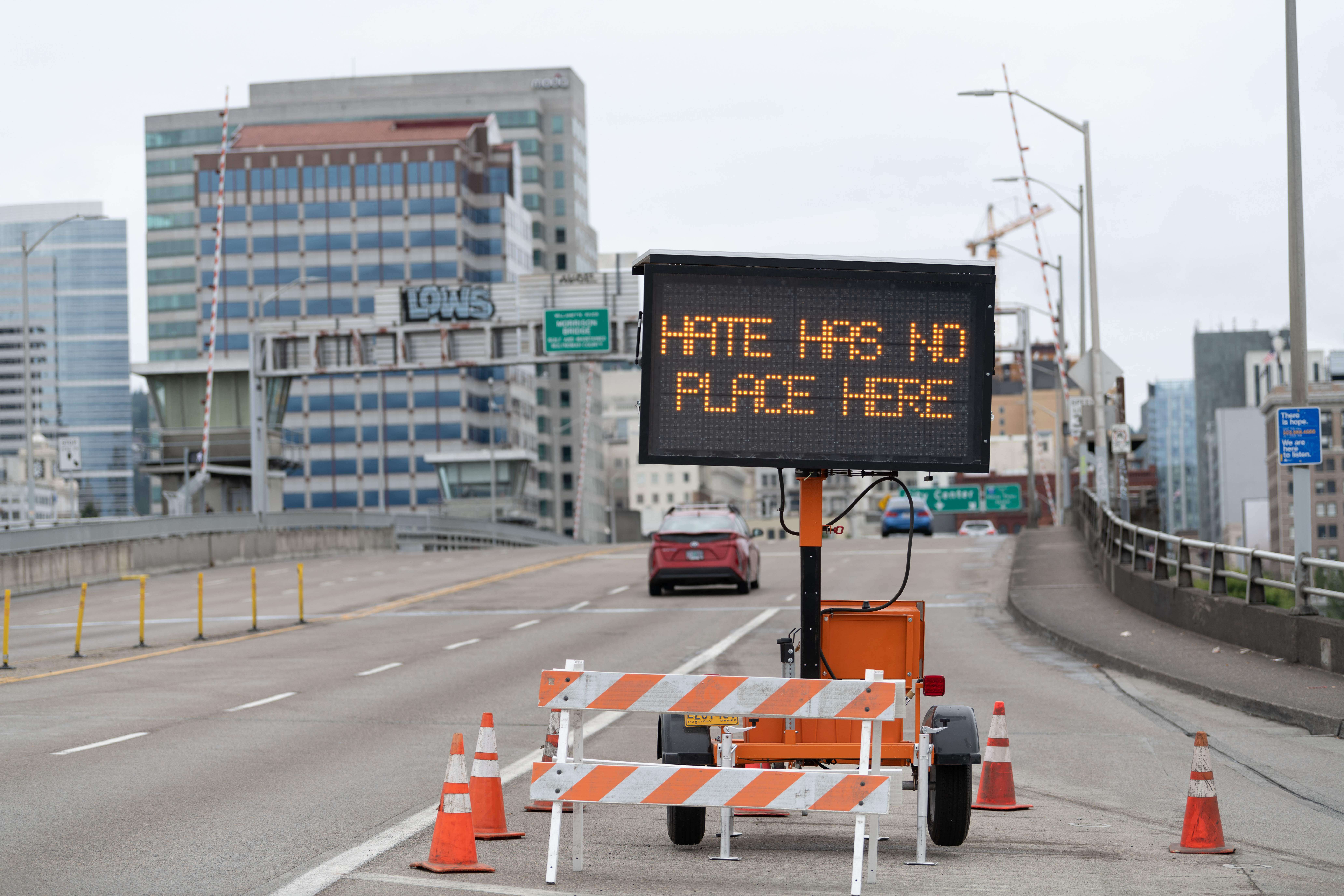 A traffic sign displays a message on a bridge in Portland, Oregon, in 2021 ahead of a far-right demonstration in the city. The Anti-Defamation League found that incidents of white supremacist propaganda more than doubled in 2022 compared to the previous year.