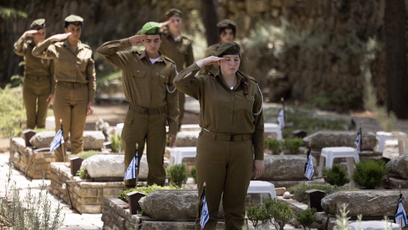 Israeli soldiers pay their respect at the Mount Herzl military cemetery in Jerusalem on May 2, 2022.