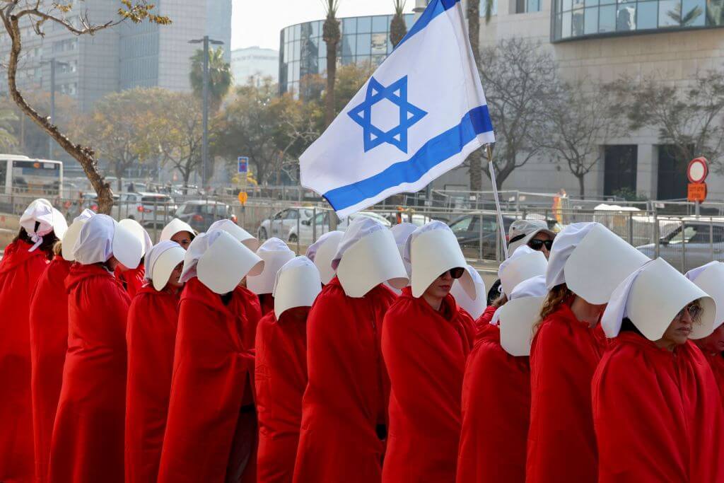 Protesters supporting women's rights dressed as characters from 'The Handmaid's Tale' TV series attend a protest in Tel Aviv on February 20, 2023.