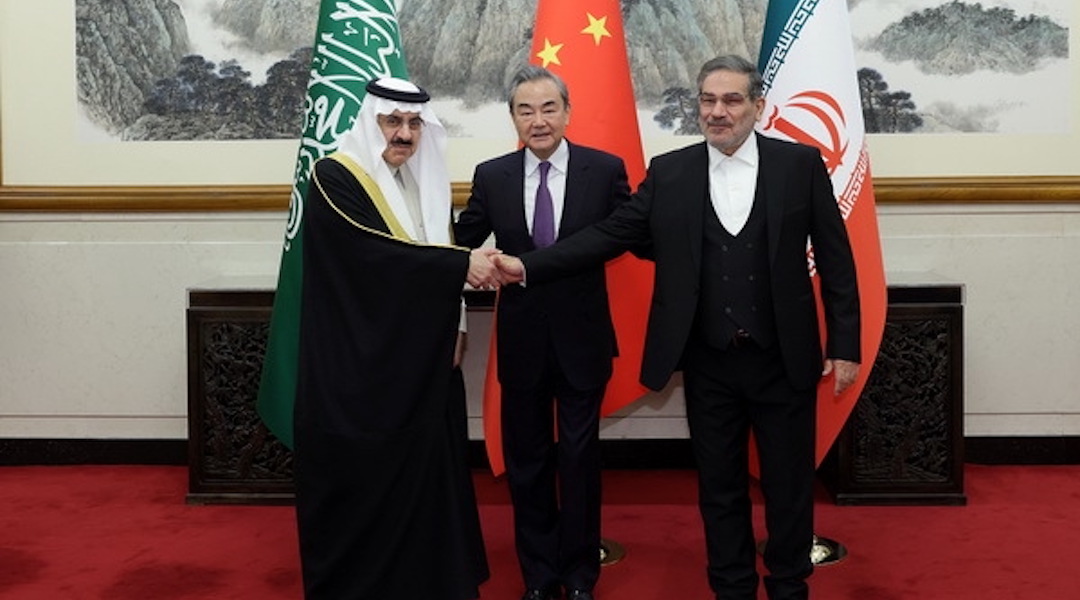 Iran’s top security official Ali Shamkhani (right), Chinese Foreign Minister Wang Yi (center) and Musaid Al Aiban, Saudi Arabia’s national security adviser, pose for a photo after Iran and Saudi Arabia agree to resume bilateral diplomatic ties (Chinese Foreign Ministry/Anadolu Agency via Getty Images)