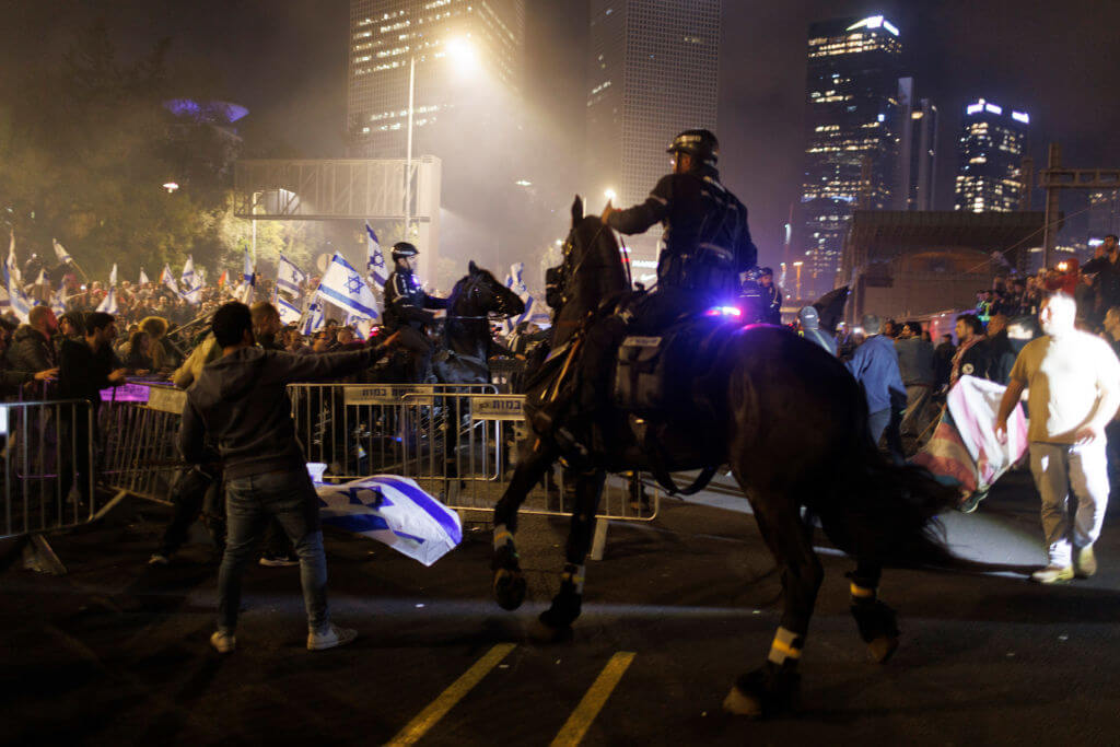 A mounted Israeli police officer clashes with demonstrators on the Ayalon Highway during a protest against prime minister Benjamin Netanyahus coalition government and proposed judicial reforms in Tel Aviv, Israel, on Sunday, March 26, 2023.