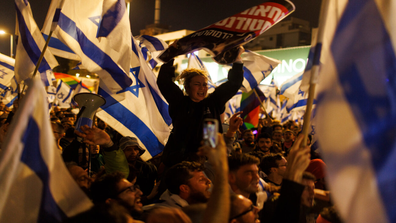 Demonstrators wave Israeli national flags as they block the Ayalon Highway during a protest against prime minister Benjamin Netanyahu's coalition government and proposed judicial reforms in Tel Aviv, Israel, on Sunday, March 26, 2023.