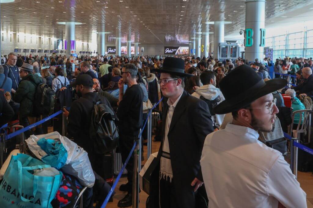 Passengers wait for their flights during a strike at departures hall in Ben-Gurion International airport near Tel Aviv, on March 27, 2023.