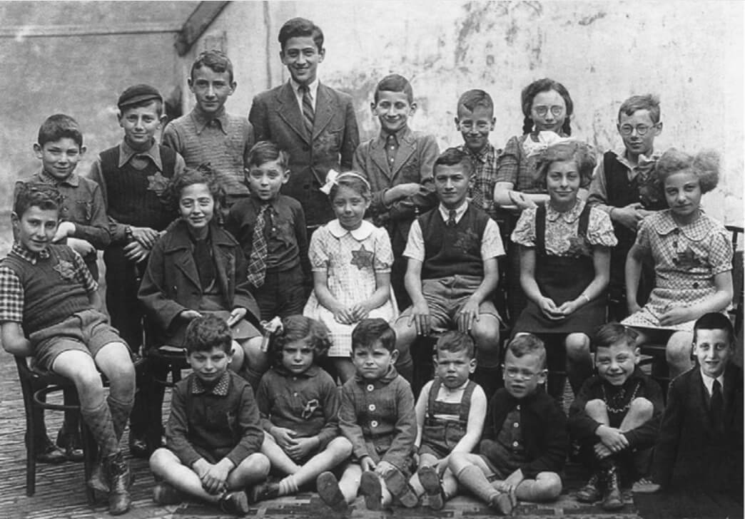 At the Etty Hillesum Center, a haunting school photo features 22 smiling children, their mandatory yellow stars sewn to their fine clothing.