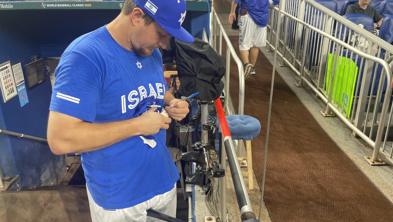 Team Israel outfielder Alex Dickerson signs an autograph at the World Baseball Classic.