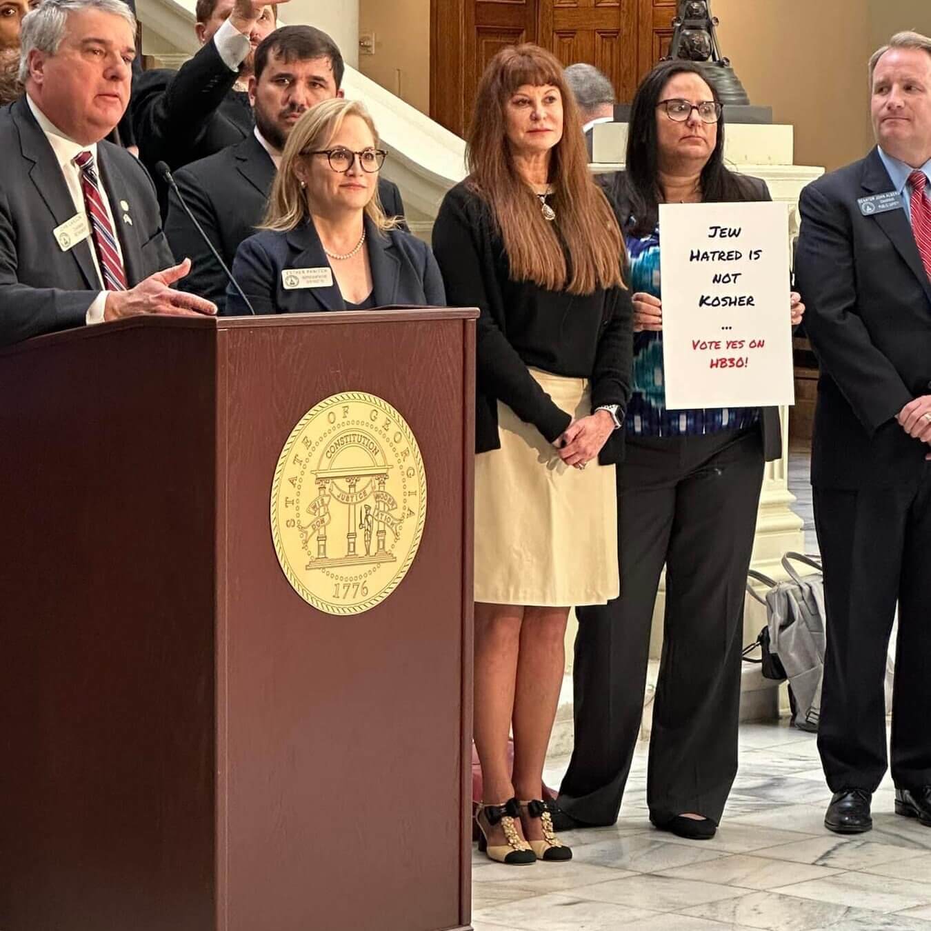 Georgia State Representatives John Carson and Esther Panitch stand with members of Jewish organizations.  The two jointly supported a bill to combat anti-Semitism. 