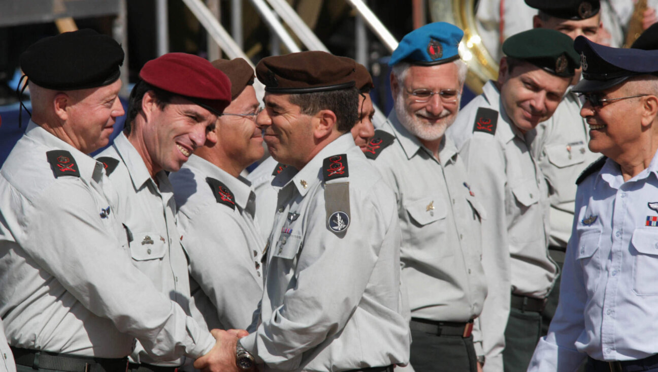 New Israeli Chief of Staff Lt. Gen. Gabi Ashkenazi (L) and outgoing Chief of Staff Lt. Gen. Dan Halutz walk past army Generals during a change-over ceremony at the IDF headquarters in Tel-Aviv, 14 February 2007. 