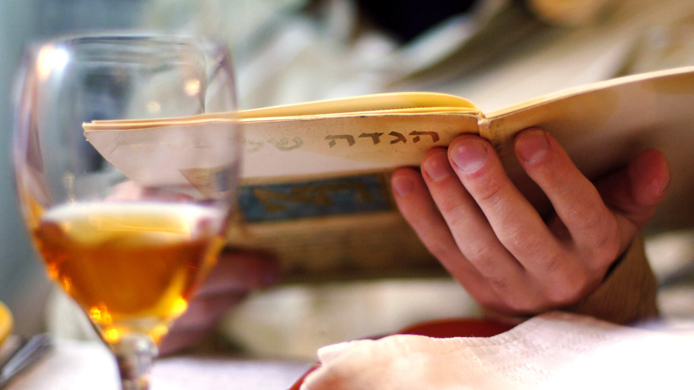 A person reads the Haggadah during the Passover Seder meal. 