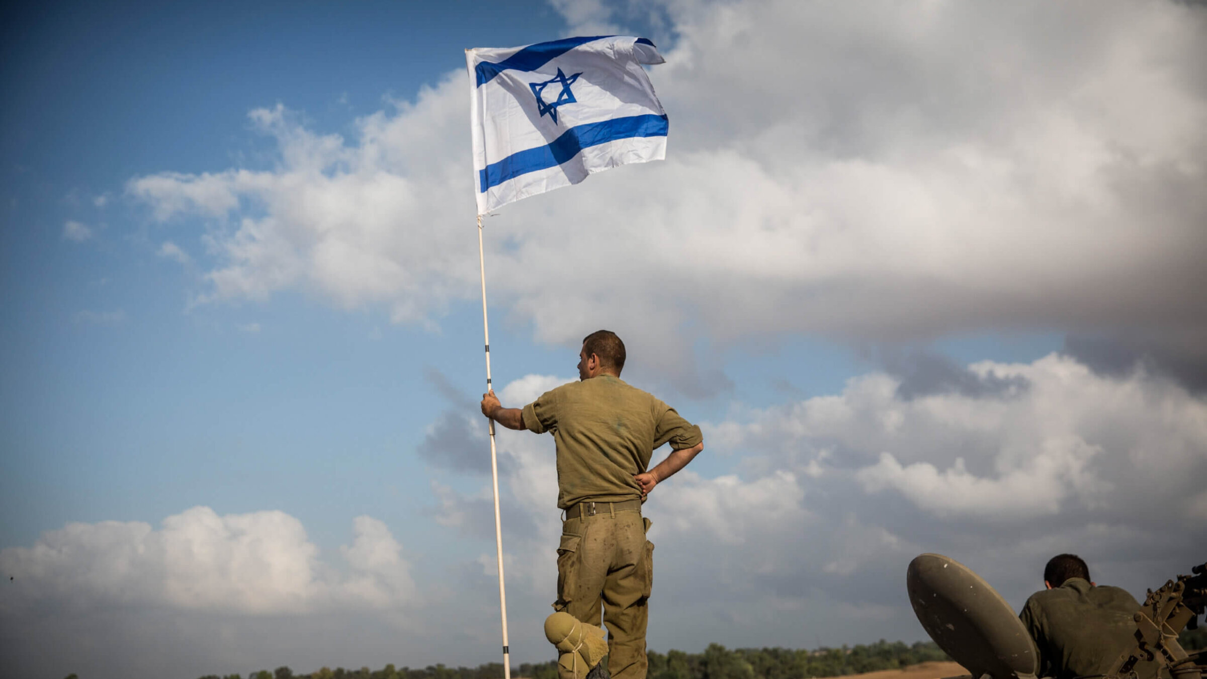 An Israeli soldier stands on top of an armored personnel carrier near the Israeli-Gaza border on July 15, 2014 near Sderot, Israel.  