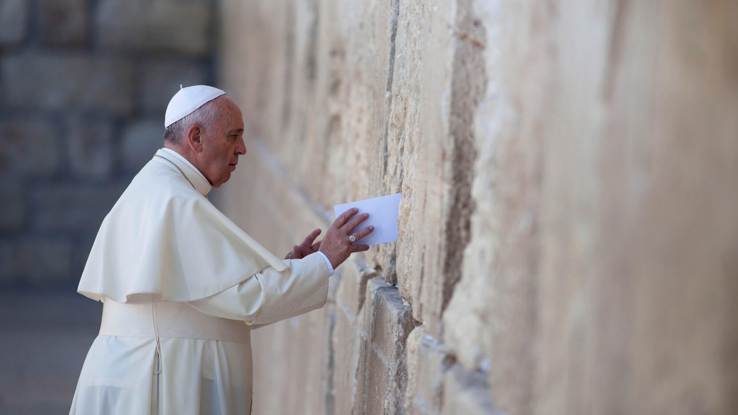Pope Francis places a prayer into the Western Wall on May 26, 2014 in Jerusalem