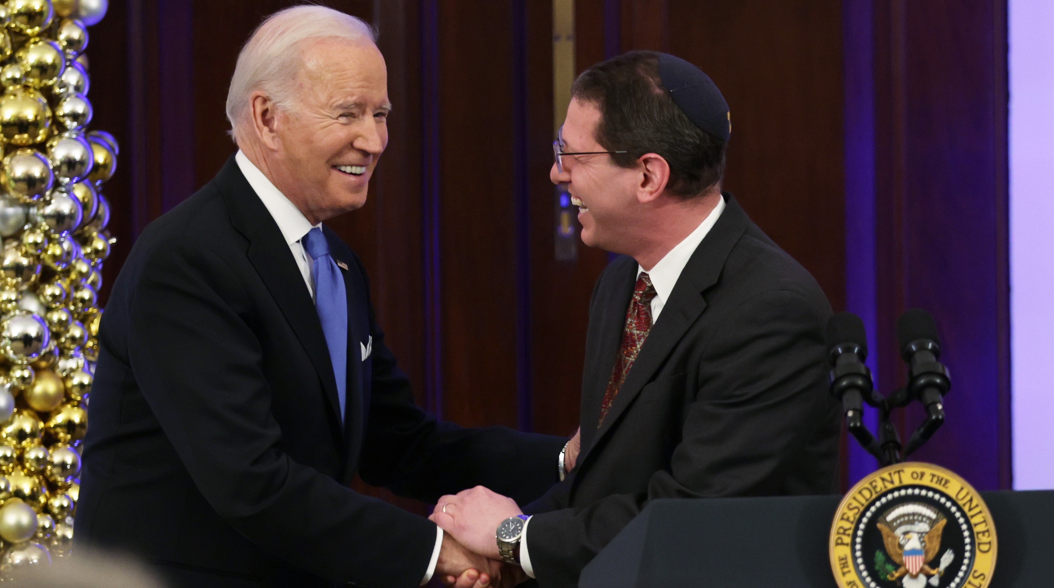 President Joe Biden shakes hands with Rabbi Charlie Cytron-Walker during a Hanukkah holiday reception in the Grand Foyer of the White House, Dec. 19, 2022. (Alex Wong/Getty Images)
