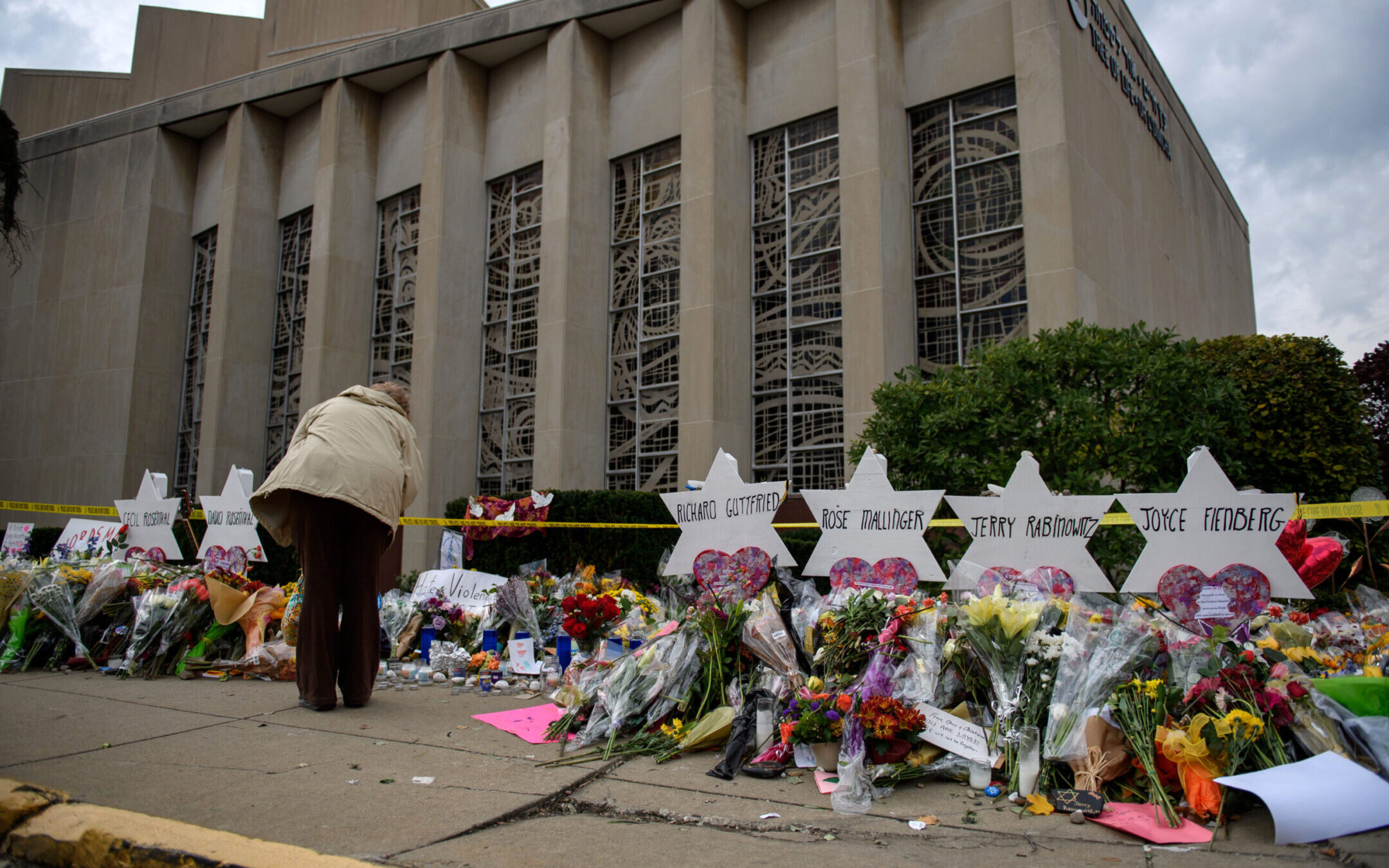 Mourners visit the memorial outside the Tree of Life Synagogue, Oct. 31, 2018 in Pittsburgh, Pennsylvania, four days after 11 Jewish worshippers were killed during services there. The alleged shooter’s trial begins April 24, 2023. (Jeff Swensen/Getty Images)