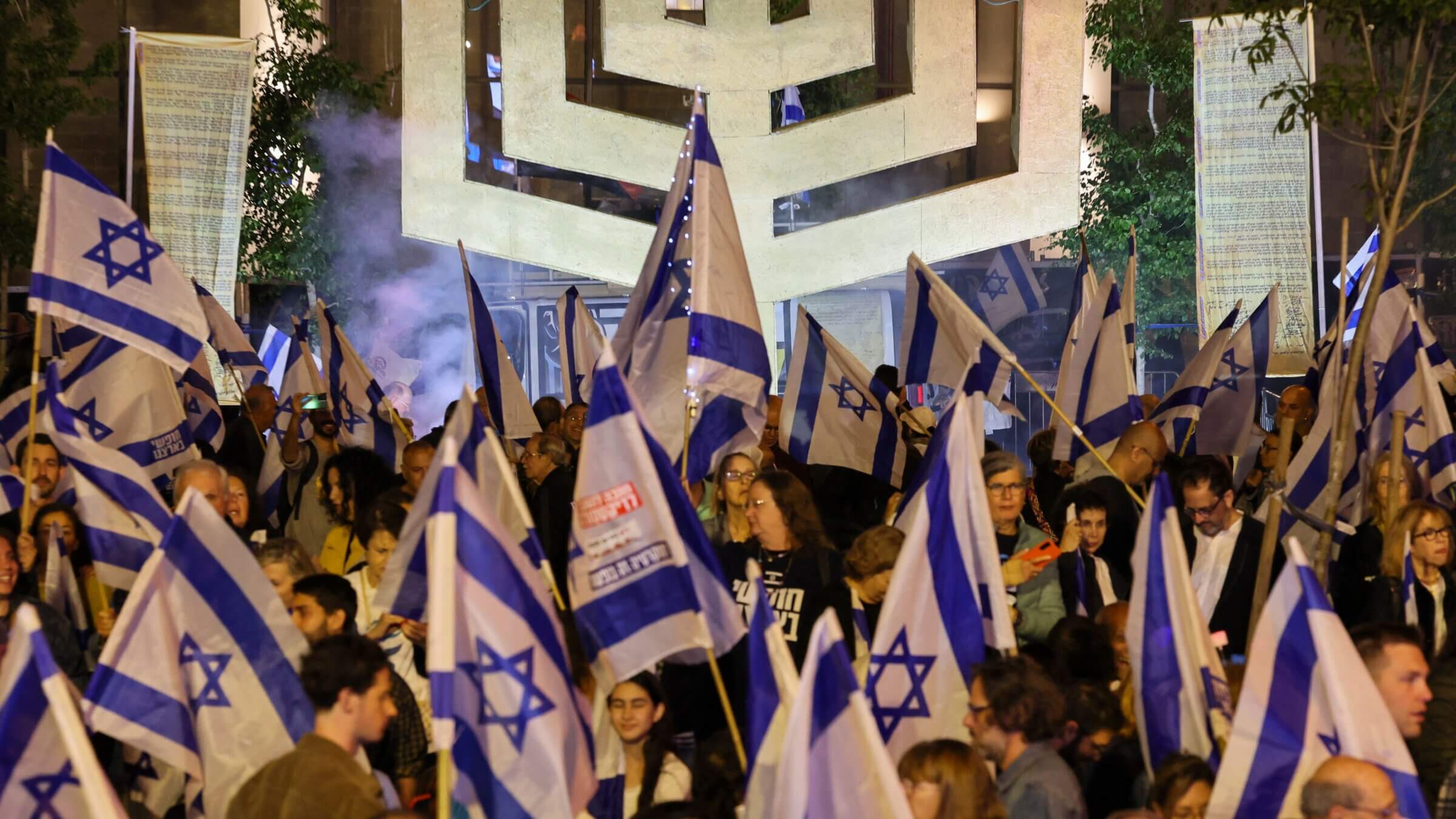 Demonstrators lifting national flags rally in Tel Aviv to protest the Israeli government's judicial overhaul bill, as the country begins celebrations for its 75th anniversary.