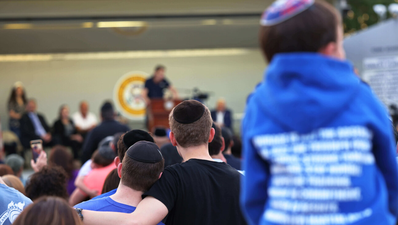 People listen to Joseph Borgen, a victim of a hate crime, speak during a rally denouncing antisemitic violence on May 27, 2021, in Cedarhurst, New York.