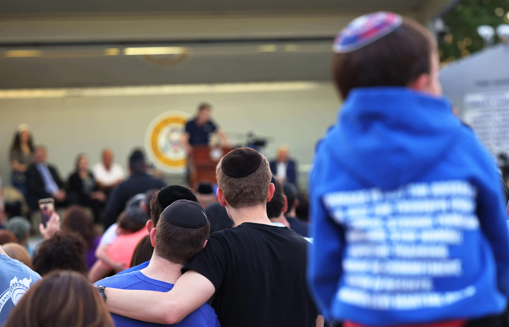 People listen to Joseph Borgen, a victim of a hate crime, speak during a rally denouncing antisemitic violence on May 27, 2021, in Cedarhurst, New York.