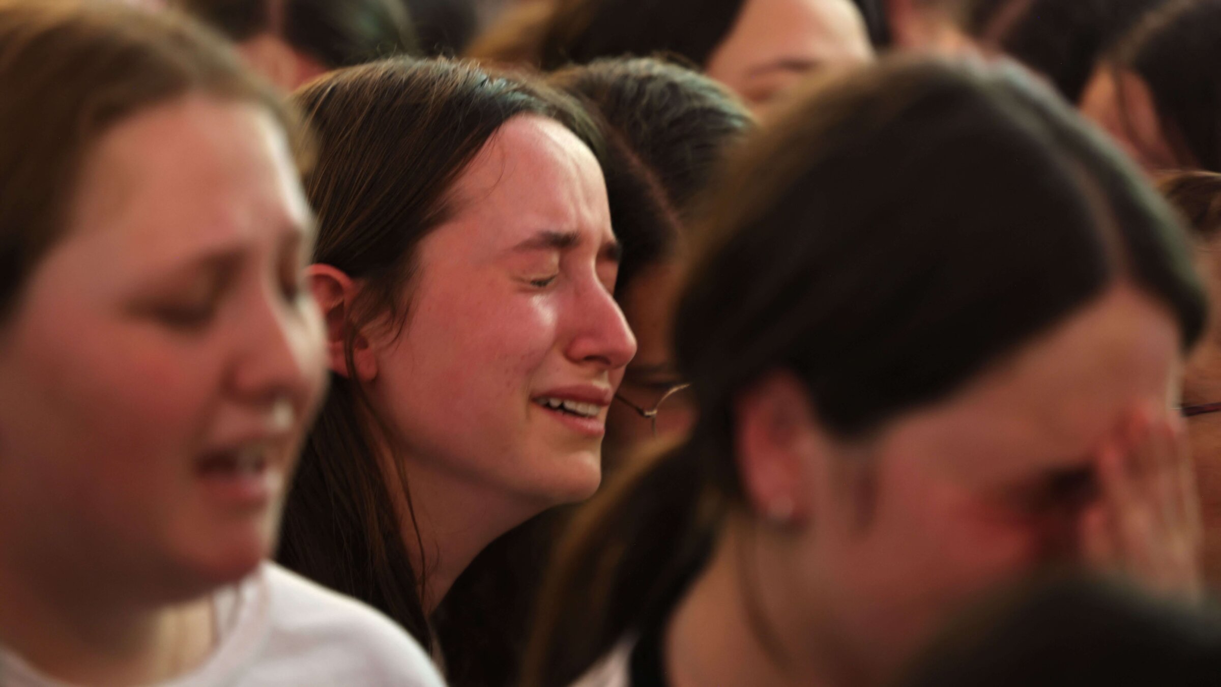 Mourners react during the funeral of British-Israeli sisters Rina and Maya Dee at the Kfar Etzion settlement cemetery in the occupied West Bank, on April 9, 2023. 