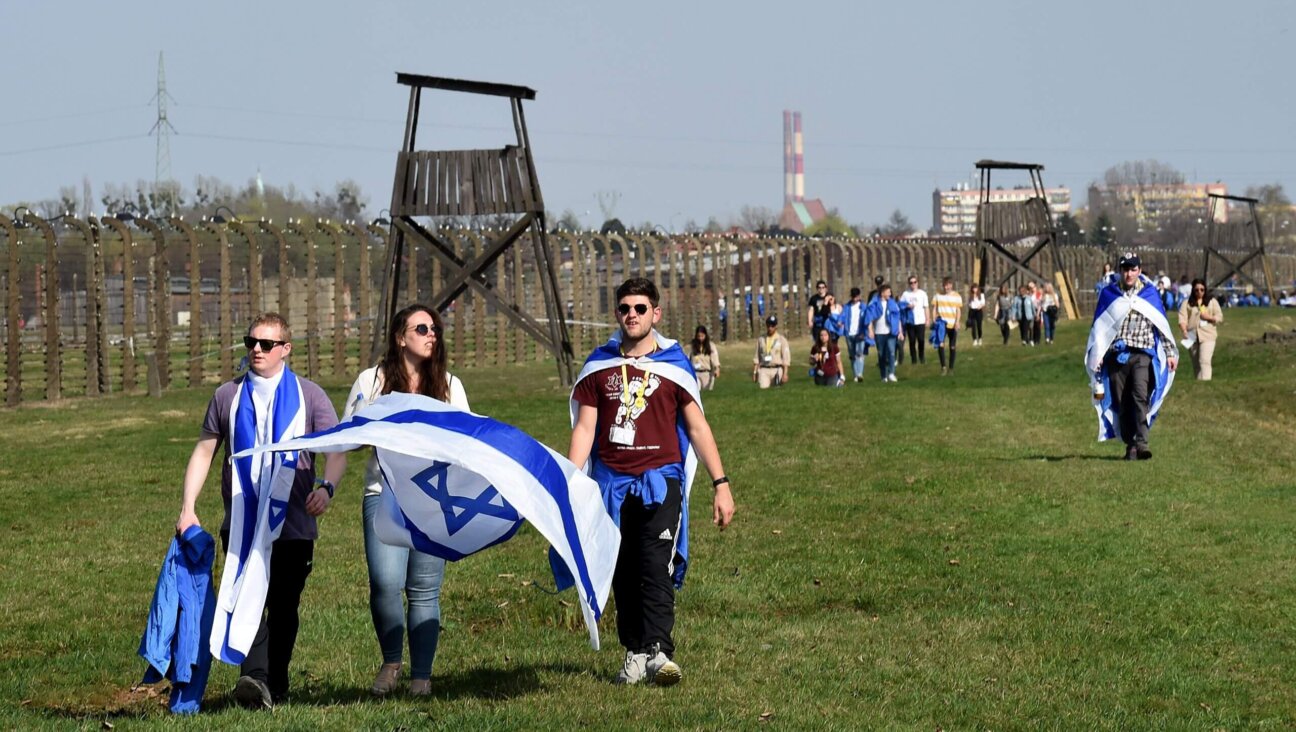 Youth hold Israeli flags during the "March of the Living", a yearly Holocaust remembrance march between the former death camps of Auschwitz and Birkenau, on April 12, 2018 in Oswiecim (Auschwitz), Poland. 
