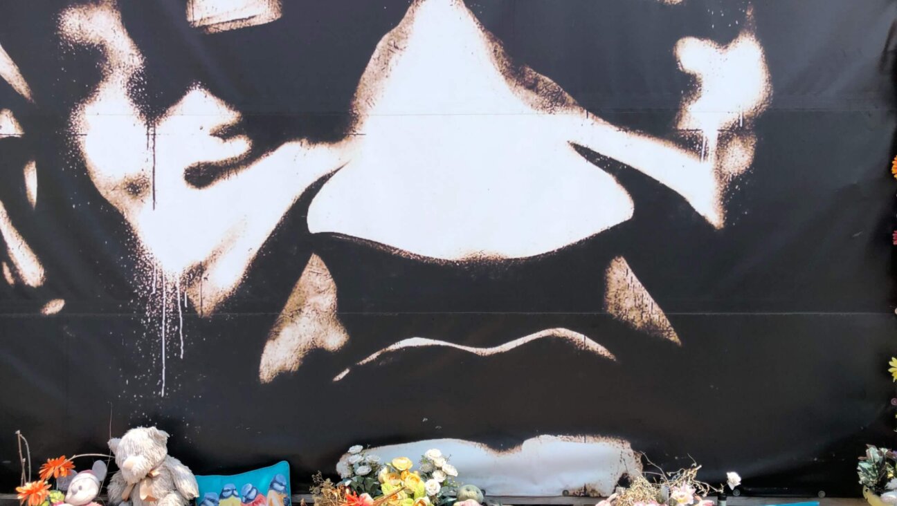 A mural of George Floyd at the Minneapolis street corner where he died, now officially George Floyd Square, is continuously adorned with flowers. 