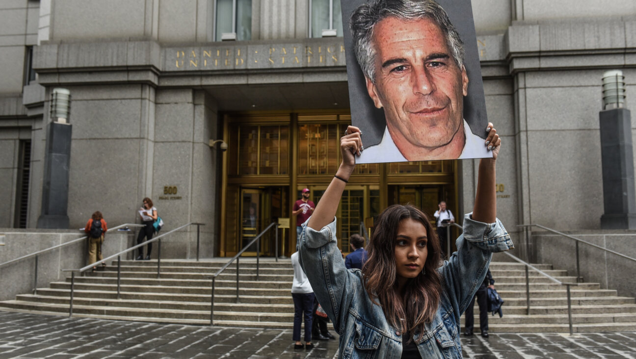 A protester holds up a sign outside federal court in New York where Jeffrey Epstein was to appear on sex trafficking charges on July 8, 2019. 
