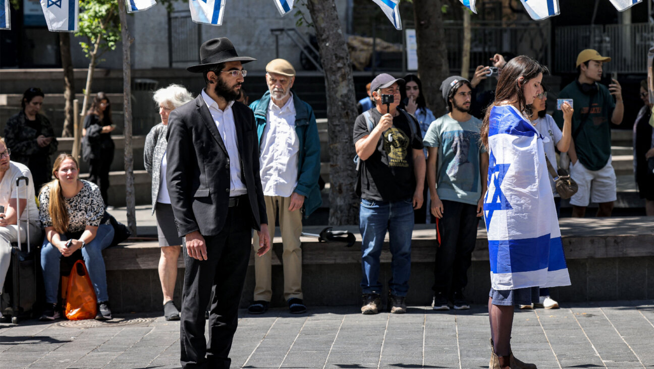 People stop and stand in silence in Jerusalem on April 25, 2023, as sirens wail for two minutes on Israel's Day of Remembrance.