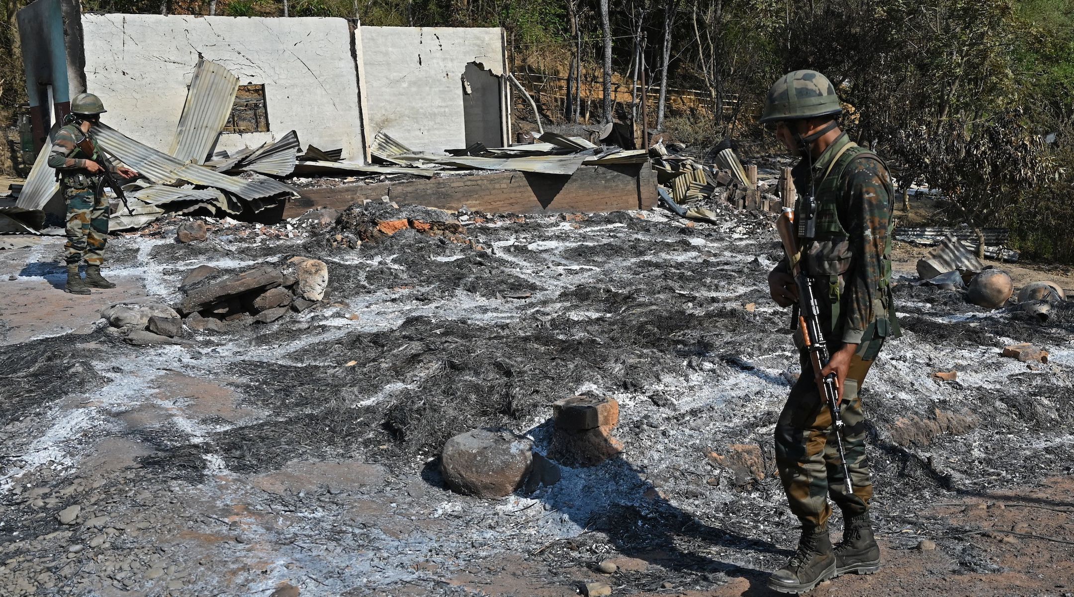 Indian army soldiers inspect the remains of a house that was set on fire by a mob in an area of a village in the Senapati district of India’s Manipur state, May 8, 2023. (Arun Sankar/AFP via Getty Images)