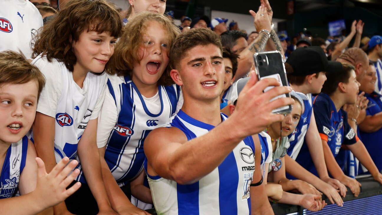 Harry Sheezel celebrates with Melbourne Kangaroos fans at Marvel Stadium in Melbourne, March 18, 2023. (Daniel Pockett/Getty Images)