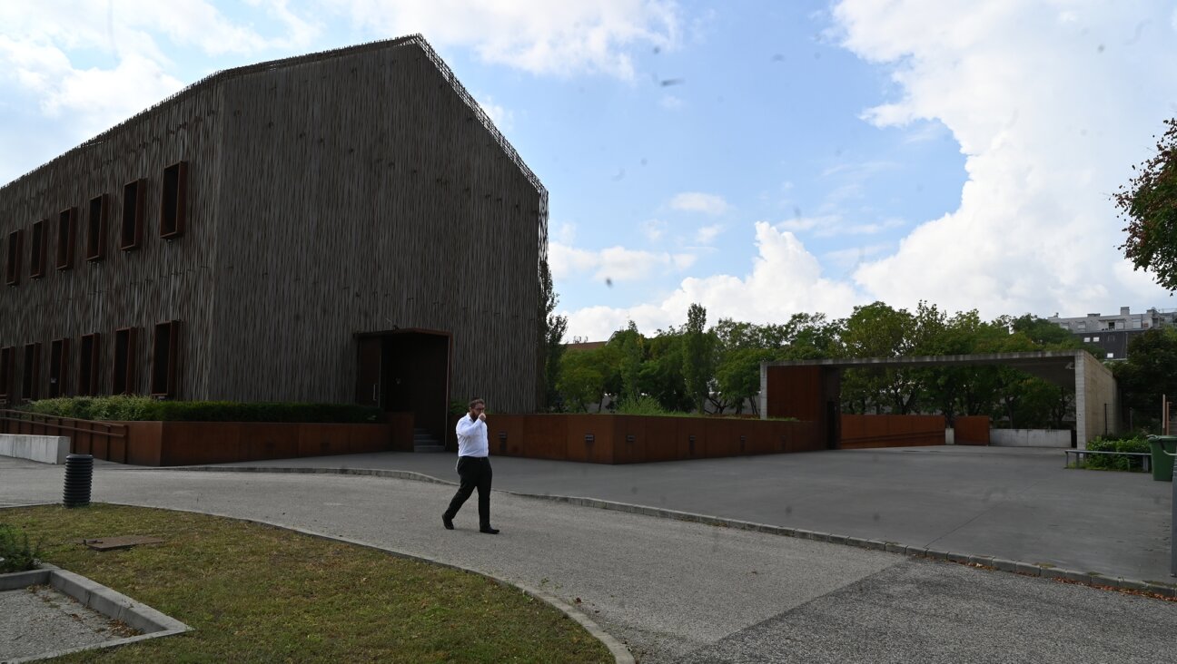 Rabbi Slomo Koves walks across the parking area of the House of Fates Holocaust museum in Budapest, Hungary on Aug. 27, 2021. (Cnaan Liphshiz)