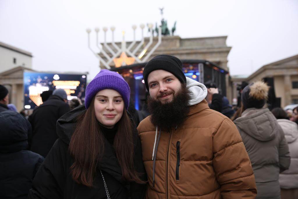 Yonatan and Miriam Yakovemko at a menorah lighting outside the famous Brandenburg Gate in Berlin. The couple fled to Germany from Ukraine when Russia invaded the country last winter.