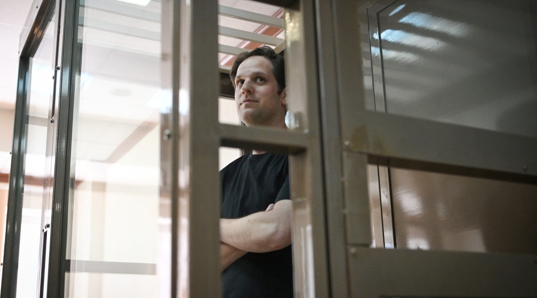 US journalist Evan Gershkovich stands inside a defendants’ cage at Moscow City Court on June 22, 2023. (Photo by NATALIA KOLESNIKOVA/AFP via Getty Images)