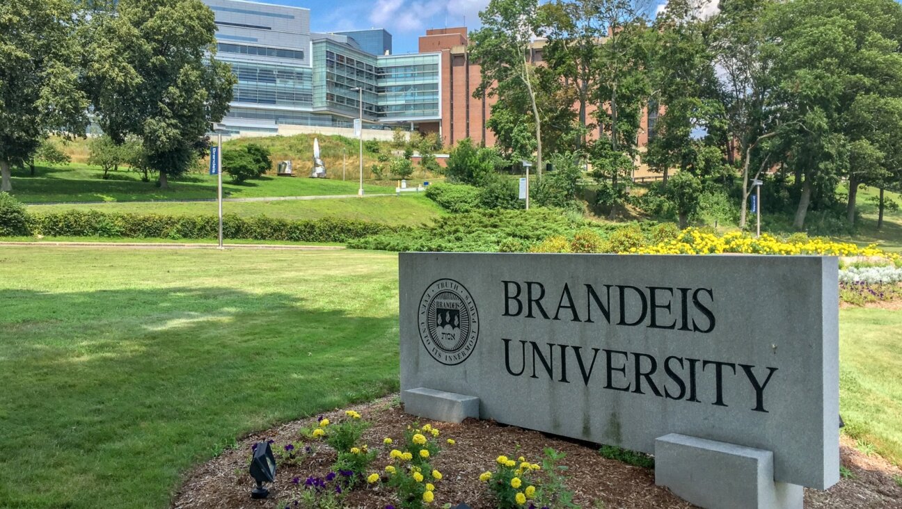 A sign on the Brandeis University campus with the school’s emblem and motto reads, “Truth even unto its innermost parts.” (Wikimedia)